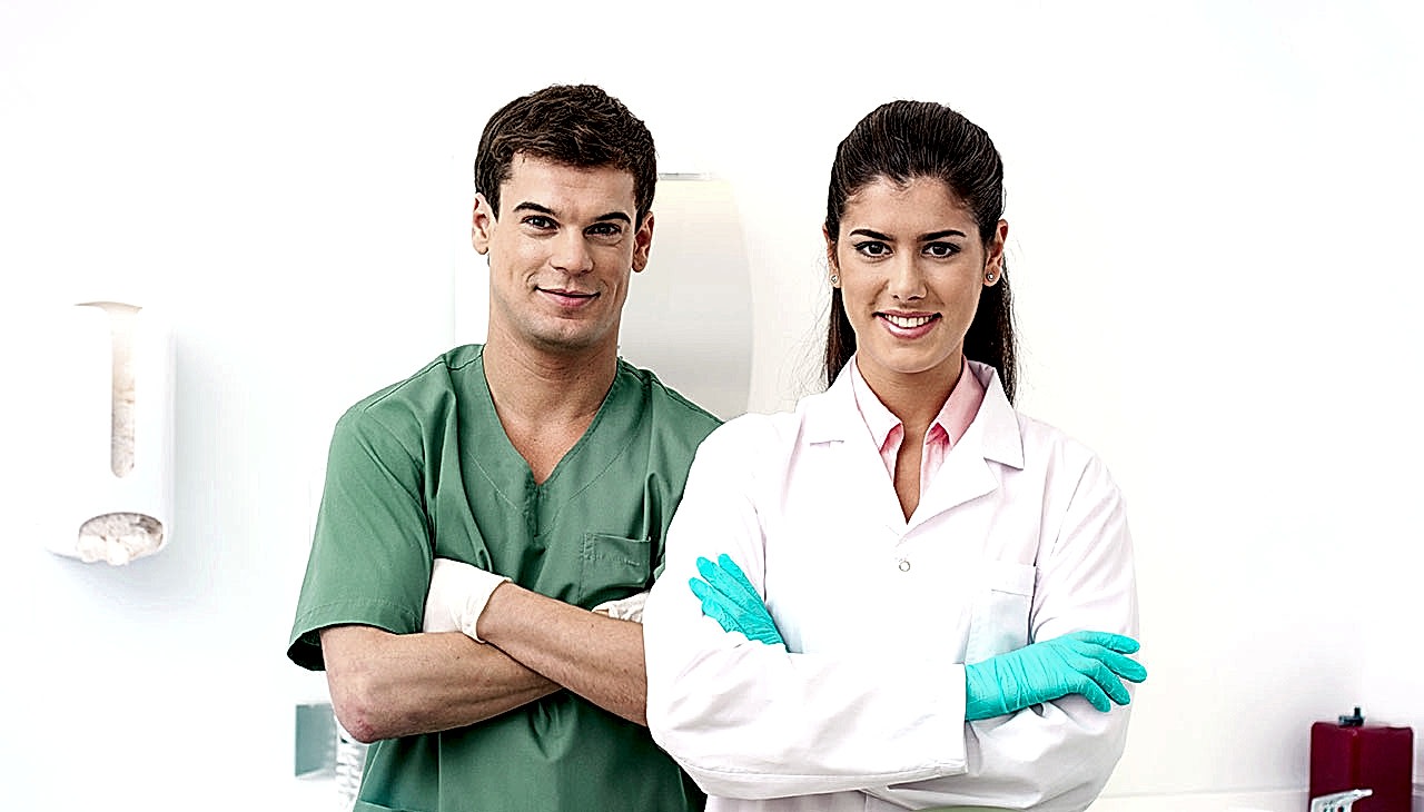 Two dentists standing in dental practice and waiting for next patient.